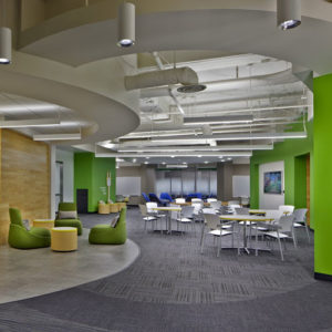 a newly renovated office commons area with new tables and chairs