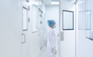 Unidentified microbiologist is open the cleanroom door to enter