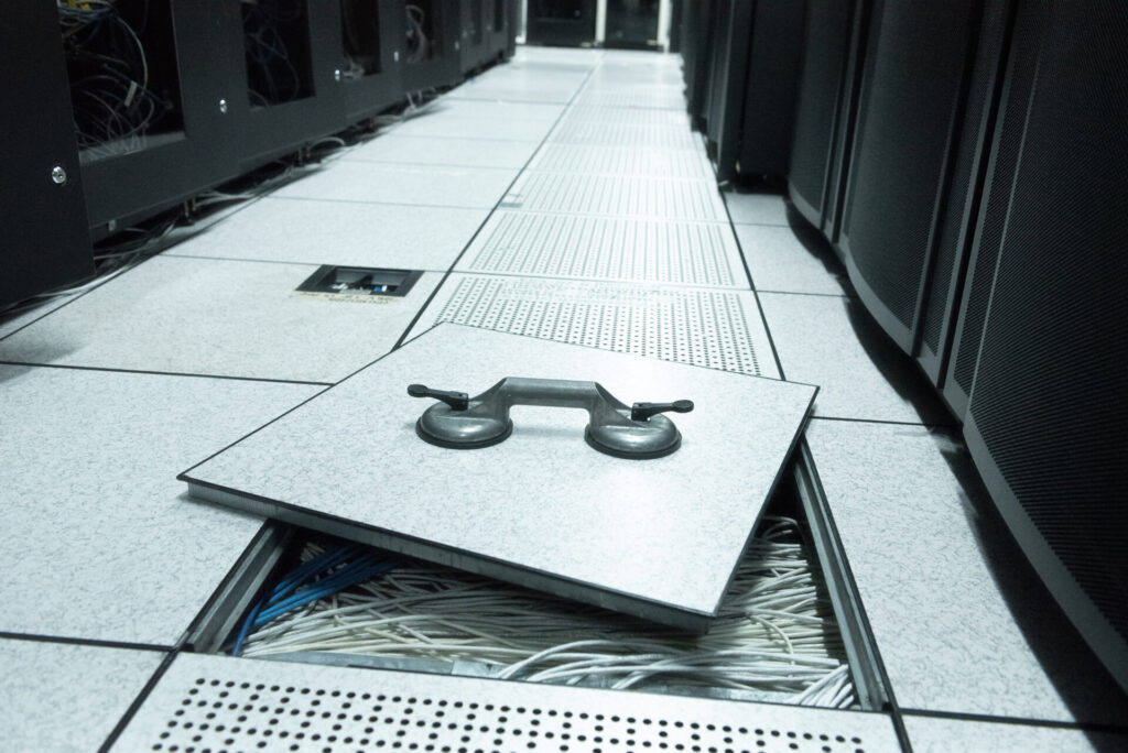 Lifted raised floor and suction tools in datacenter